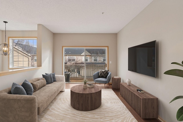 living room with a textured ceiling and an inviting chandelier