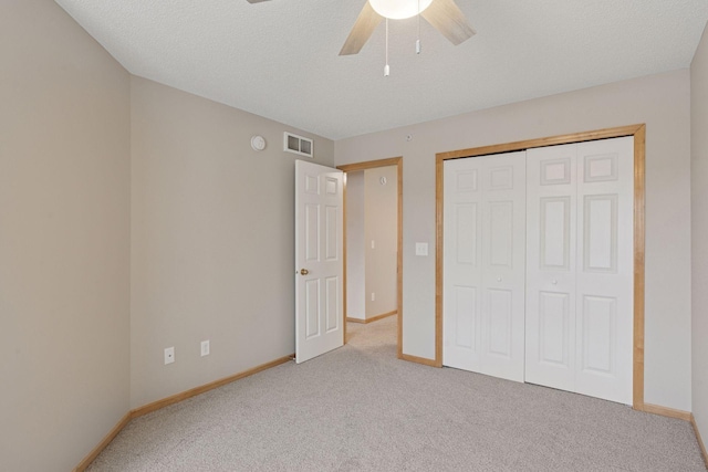 unfurnished bedroom featuring carpet, visible vents, ceiling fan, and baseboards