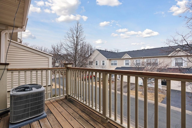 wooden terrace with a residential view and central AC unit