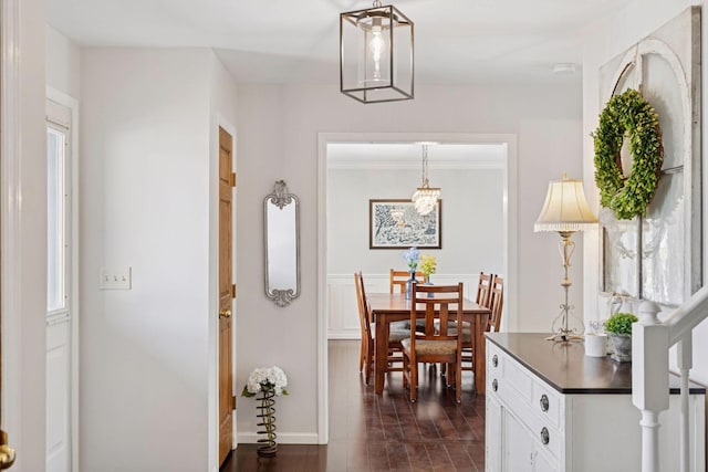 dining space featuring dark wood finished floors and ornamental molding