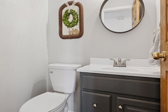 bathroom featuring toilet and vanity