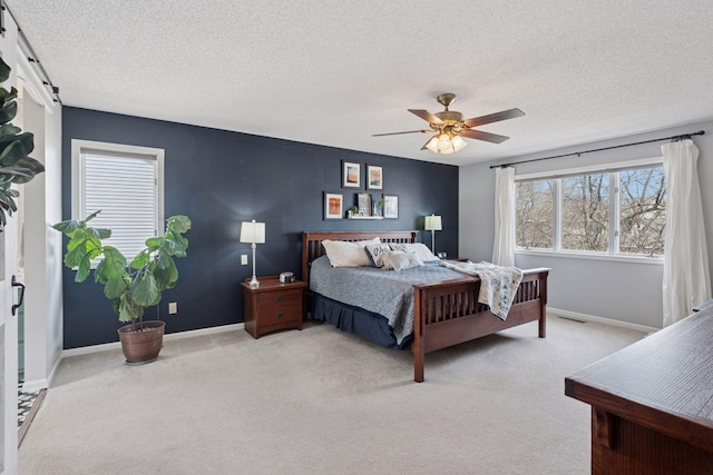 bedroom featuring visible vents, a textured ceiling, baseboards, and carpet floors