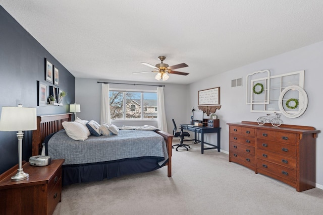 carpeted bedroom featuring visible vents, a textured ceiling, baseboards, and ceiling fan