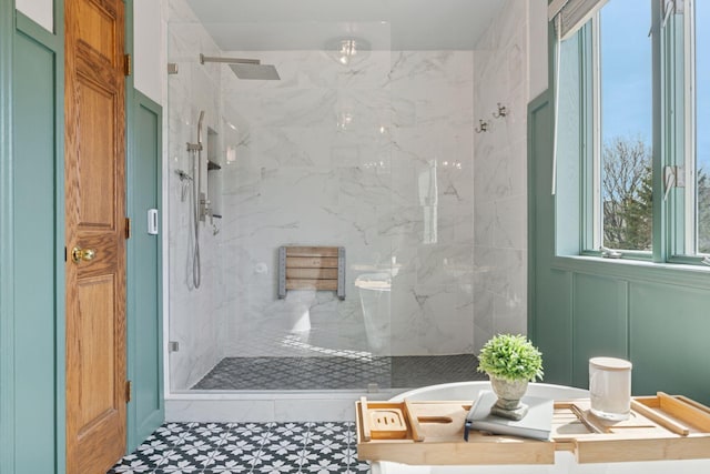 full bathroom featuring a marble finish shower