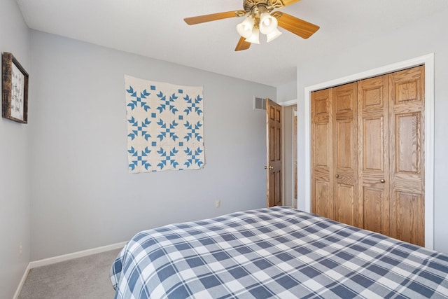 carpeted bedroom with visible vents, baseboards, a closet, and ceiling fan