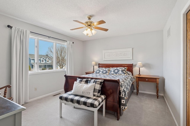 carpeted bedroom with visible vents, baseboards, and a textured ceiling