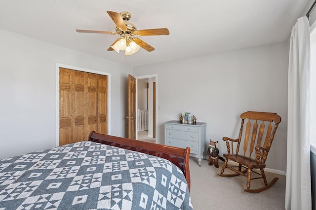 carpeted bedroom featuring a closet and ceiling fan