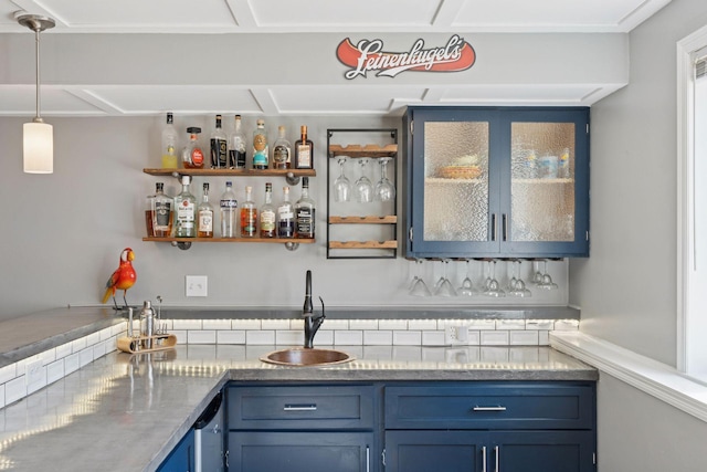 bar featuring indoor wet bar, pendant lighting, and a sink