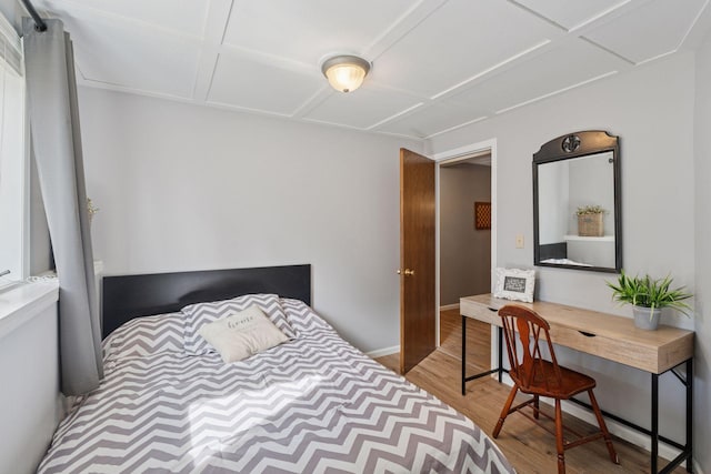 bedroom with wood finished floors and baseboards