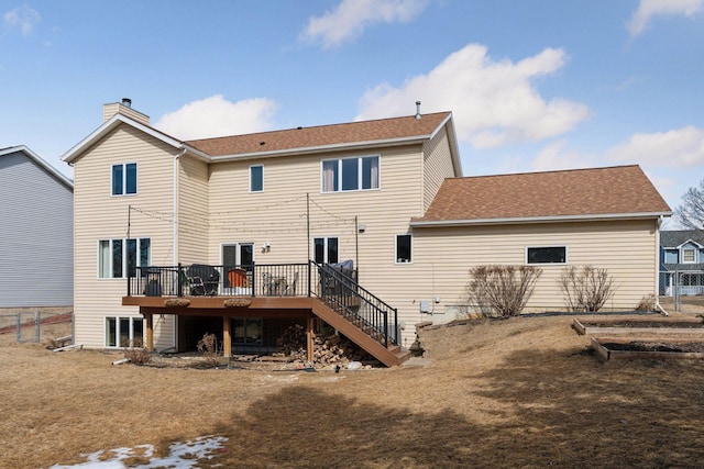 back of house featuring fence, stairway, a wooden deck, roof with shingles, and a chimney