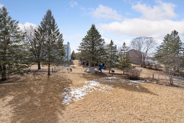 view of yard with playground community and fence