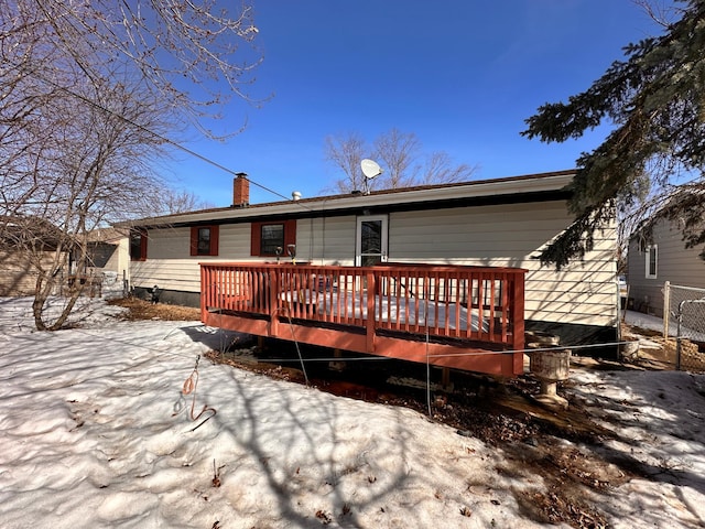 back of house with a deck and a chimney