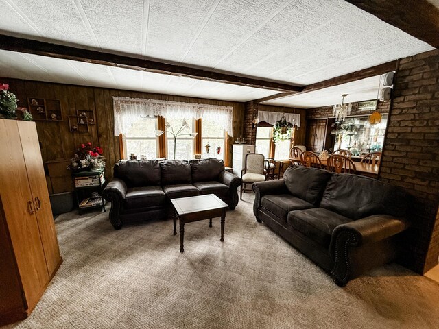 18863 State Highway 65, Goodland Twp, MN 55742 - living area featuring beamed ceiling, plenty of natural light, carpet flooring, and wooden walls