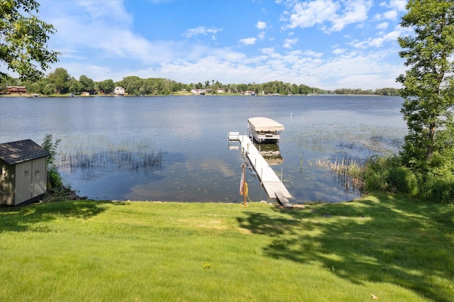 dock area featuring a water view and a lawn