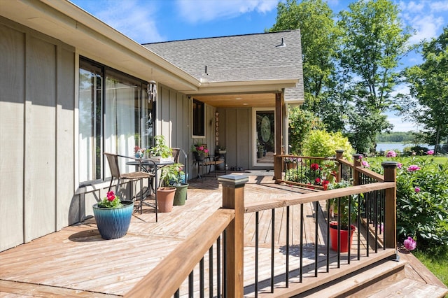 wooden terrace featuring a water view