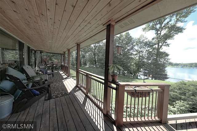 wooden terrace featuring a water view