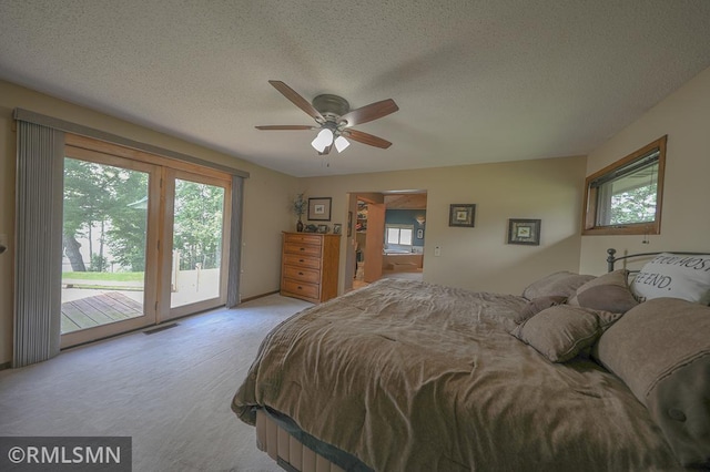 bedroom featuring access to exterior, multiple windows, and visible vents