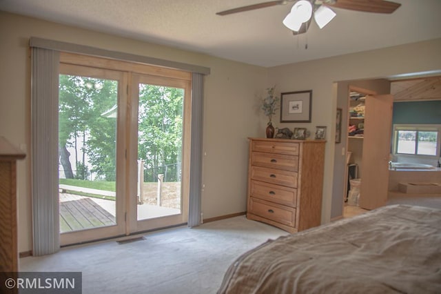 carpeted bedroom featuring baseboards, visible vents, ceiling fan, access to exterior, and a spacious closet