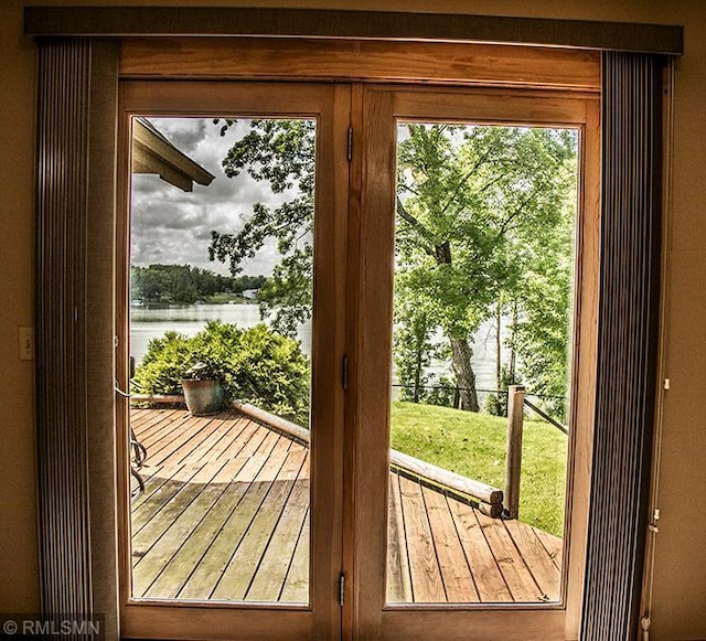 doorway to outside featuring a water view