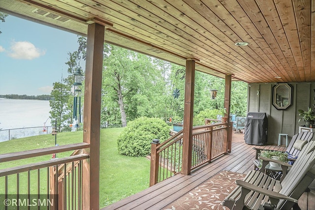 sunroom / solarium featuring wooden ceiling and a water view