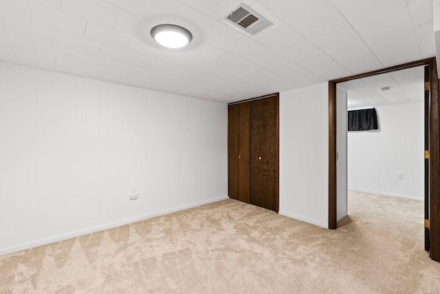 unfurnished bedroom with a closet, visible vents, and light colored carpet