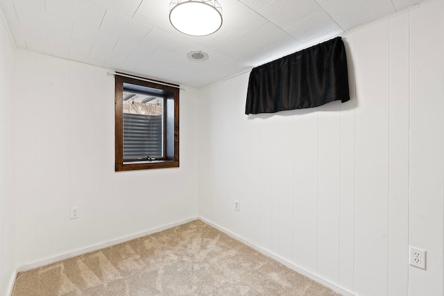 empty room with light colored carpet and baseboards