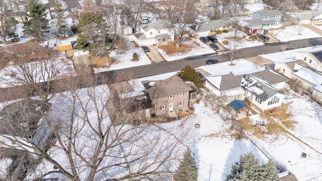 snowy aerial view featuring a residential view