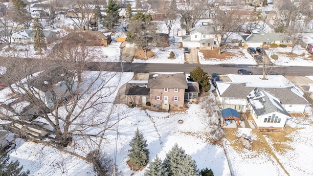 snowy aerial view with a residential view