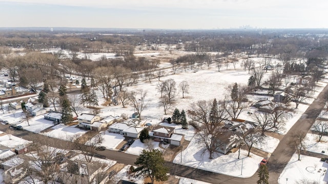 snowy aerial view with a residential view