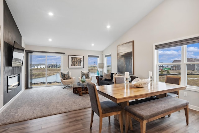 dining area with wood finished floors, a wealth of natural light, and recessed lighting