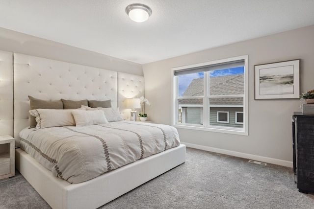 carpeted bedroom featuring visible vents and baseboards