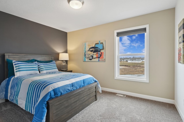 carpeted bedroom featuring visible vents and baseboards