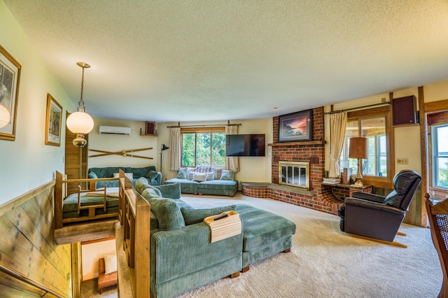 living room featuring a textured ceiling, a wainscoted wall, a fireplace, carpet flooring, and a wall mounted AC