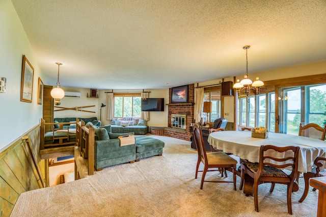 carpeted dining room featuring a textured ceiling, wainscoting, a wall mounted AC, and a fireplace