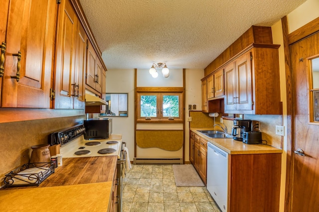 kitchen with light countertops, baseboard heating, a sink, white appliances, and under cabinet range hood