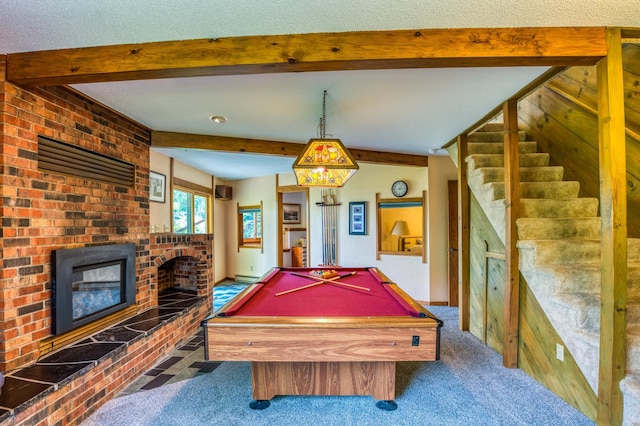 recreation room with a textured ceiling, carpet floors, billiards, a brick fireplace, and beam ceiling