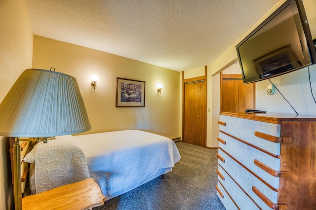 bedroom featuring a closet, carpet flooring, and a textured ceiling