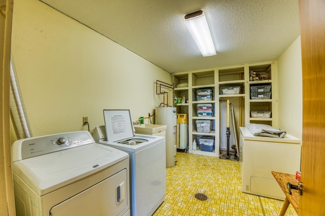 laundry area with laundry area, independent washer and dryer, a textured ceiling, light floors, and water heater