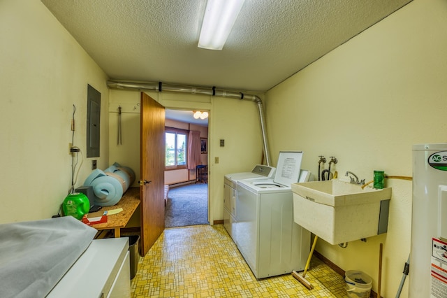 washroom with a textured ceiling, electric water heater, a sink, washer and dryer, and electric panel