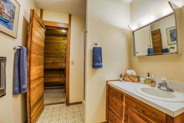 full bath with vanity, a shower stall, and tile patterned floors