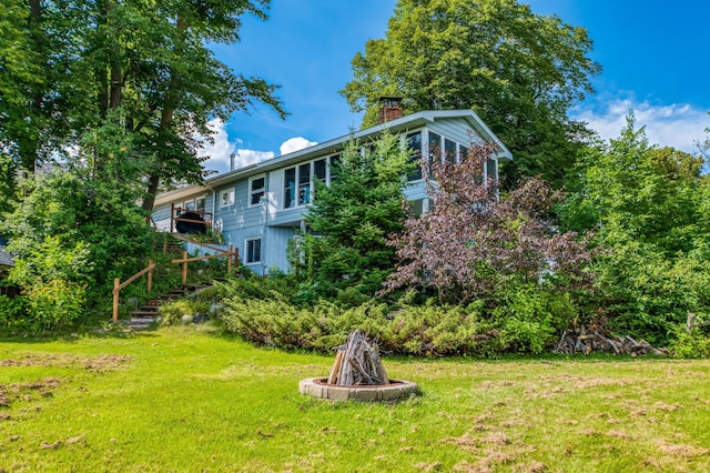 view of yard with a fire pit