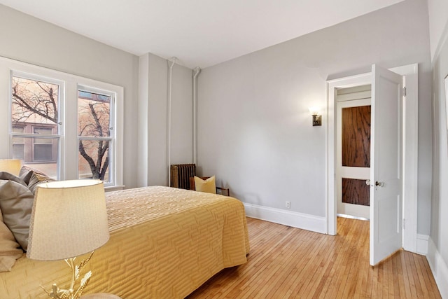 bedroom featuring light wood-style floors and baseboards