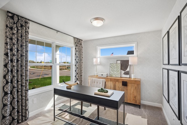 office featuring baseboards, wallpapered walls, and light colored carpet