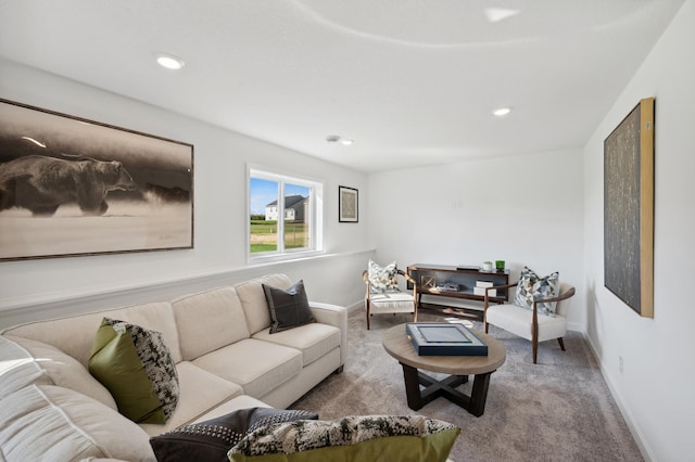 living room featuring baseboards, recessed lighting, and light colored carpet