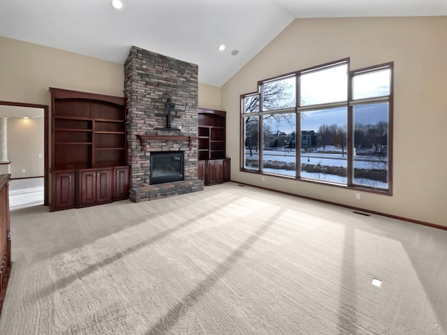 unfurnished living room featuring light carpet, visible vents, baseboards, a fireplace, and high vaulted ceiling