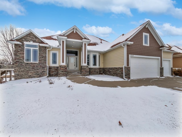 view of front of property with an attached garage and stone siding