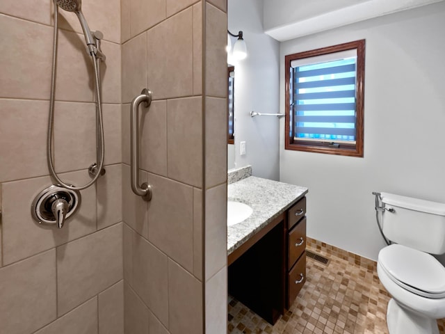 full bath with toilet, visible vents, a tile shower, and vanity