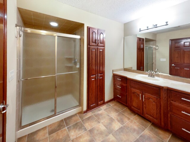 2464 Tournament Players Cir N, Blaine, MN 55449 - bathroom with a stall shower, vanity, a textured ceiling, tile patterned floors, and recessed lighting