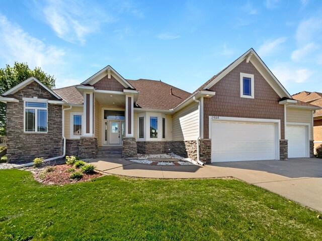 2464 Tournament Players Cir N, Blaine, MN 55449 - craftsman inspired home with stone siding, a front lawn, driveway, and roof with shingles
