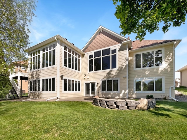 2464 Tournament Players Cir N, Blaine, MN 55449 - rear view of property featuring a patio area, a yard, and stairs